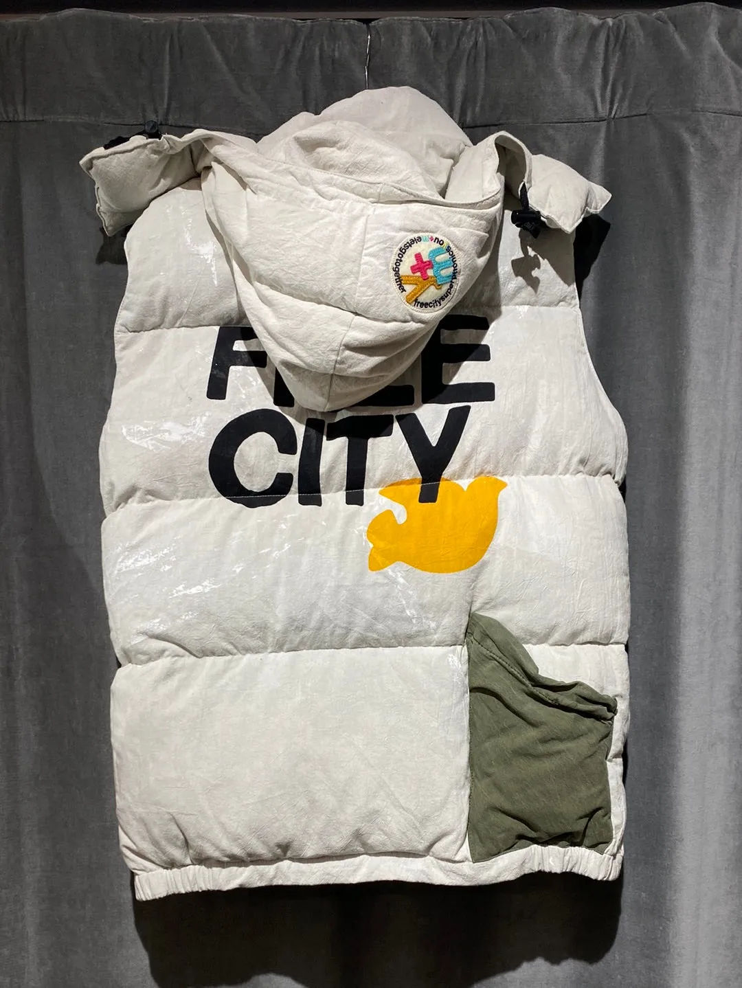 Free City Puffer Vest with Yellow Logo and Paint Hooded